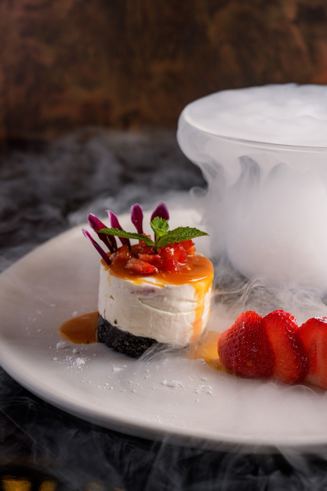 A plated dessert with strawberries at AVA Steakhouse